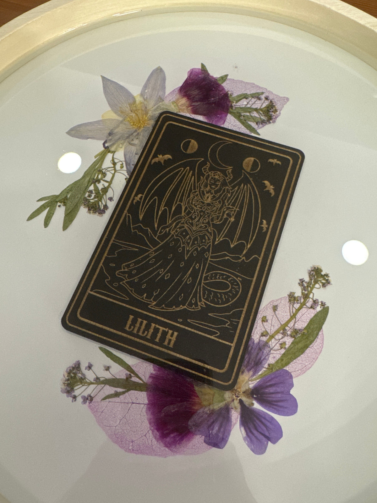 Lilith Black Card Round Wood Resin Art Piece with Purple and Green Pressed Flowers